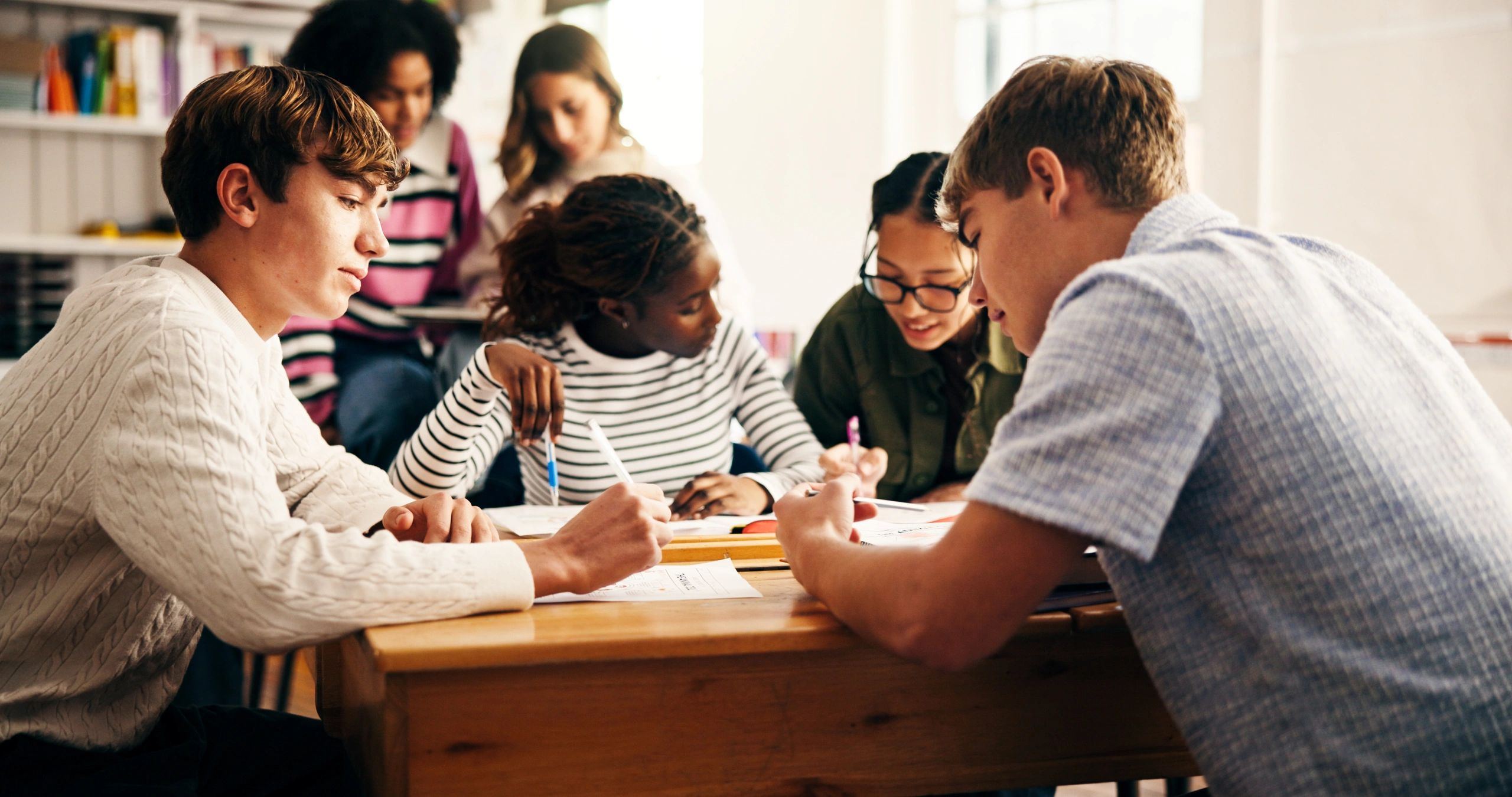 Students collaborating around a classroom table